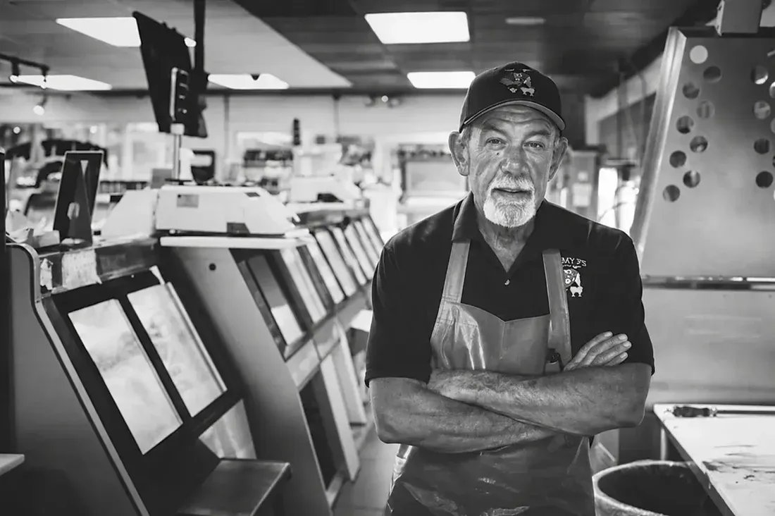 Black-and-white portrait of a butcher inside Jimmy P's